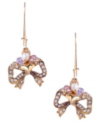 Add a little sweet shimmer to your look. Betsey Johnson's adorable bow earrings are decorated with round-cut clear crystals with small purple and pink cherry bead accents. Crafted in antique gold-plated mixed metal. Approximate drop: 1-3/4 inches. Add a little sweet shimmer to your look. Betsey Johnson's adorable bow earrings are decorated with round-cut clear crystals with small purple and pink cherry bead accents. Crafted in antique gold-plated mixed metal. Approximate drop: 1-3/4 inches.