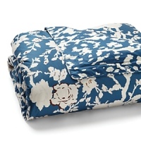 Floral branches, accented in rust and gold, are silhouetted against a bold blue background in this printed duvet from DIANE von FURSTENBERG. Floral branches, accented in rust and gold, are silhouetted against a bold blue background in this printed duvet from DIANE von FURSTENBERG.