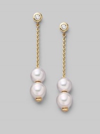 From the Pearls in Motion Collection. Delicate chains of 18k gold dangle from diamond studs and hold white Akoya pearls that slide up and down but stay where you place them. 7mm white round cultured pearls Quality: A+ Diamonds, 0.14 tcw 18k yellow gold Drop, about 1¾ Post back Imported
