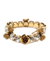 Slip some sweet style and sparkle over your wrists with this chic Betsey Johnson bracelet. Bracelet stretches to fit the wrist and features rows of round-cut crystal, flower and ribbon charms. Crafted in antique gold tone mixed metal. Approximate diameter: 2-1/4 inches. Slip some sweet style and sparkle over your wrists with this chic Betsey Johnson bracelet. Bracelet stretches to fit the wrist and features rows of round-cut crystal, flower and ribbon charms. Crafted in antique gold tone mixed metal. Approximate diameter: 2-1/4 inches.