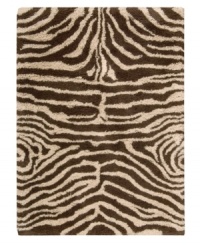 Exotic designs will be the pride of your decor. Adorned with zebra stripes in ivory and brown, this Nourison rug has a marvelously soft and shaggy pile that's hand-tufted from premium-quality yarns. Beautiful in appearance and plush underfoot, this area rug creates an atmosphere of casual elegance. (Clearance) Exotic designs will be the pride of your decor. Adorned with zebra stripes in ivory and brown, this Nourison rug has a marvelously soft and shaggy pile that's hand-tufted from premium-quality yarns. Beautiful in appearance and plush underfoot, this area rug creates an atmosphere of casual elegance. (Clearance)