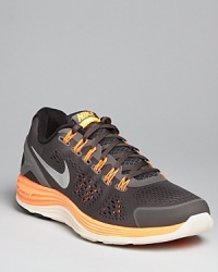 These sporty sneakers feature an accelerated high-energy design with neon accents and sci-fi inspired ribbing at the outer sole. From Nike, classic and contemporary with an unwavering focus on athletic performance. These sporty sneakers feature an accelerated high-energy design with neon accents and sci-fi inspired ribbing at the outer sole. From Nike, classic and contemporary with an unwavering focus on athletic performance.