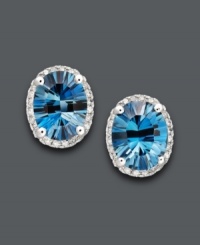 A perfectly packaged present. These stunning stud earrings feature oval-cut London blue topaz (4-1/2 ct. t.w.) surrounded by halos of sparkling diamonds (1/8 ct. t.w.). Post setting crafted in 14k white gold. Approximate diameter: 1/2 inch. A perfectly packaged present. These stunning stud earrings feature oval-cut London blue topaz (4-1/2 ct. t.w.) surrounded by halos of sparkling diamonds (1/8 ct. t.w.). Post setting crafted in 14k white gold. Approximate diameter: 1/2 inch.