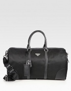 Tessuto nylon travel duffel with textured saffiano leather trim and logo detail.Zip closureDouble top handlesAdjustable shoulder strapInterior zip pocketIdentification tagNylon20W x 10H x 9DMade in Italy