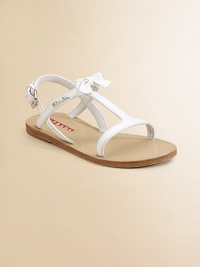 T-strap patent leather sandals with buckle closure, bow and logo detail.Adjustable buckle closurePatent leather upperRubber soleImported T-strap patent leather sandals with buckle closure, bow and logo detail.Adjustable buckle closurePatent leather upperRubber soleImported