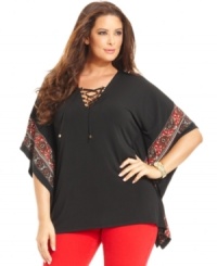 Lace-up a stylish look with MICHAEL Michael Kors' batwing sleeve plus size top, punctuated by a border print. Lace-up a stylish look with MICHAEL Michael Kors' batwing sleeve plus size top, punctuated by a border print.
