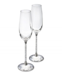 A flurry of sparkling miniature crystals fill the stems of these toasting flutes. Exquisitely crafted by Swarovski, the Austrian leader in crystal artistry for over 100 years, this pair of champagne flutes with embellished bases is cut from solid crystal. 2-3/4 x 10 high. A flurry of sparkling miniature crystals fill the stems of these toasting flutes. Exquisitely crafted by Swarovski, the Austrian leader in crystal artistry for over 100 years, this pair of champagne flutes with embellished bases is cut from solid crystal. 2-3/4 x 10 high.