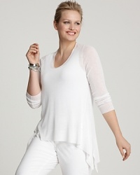 Rendered in a light-as-air knit, this Eileen Fisher tunic is designed with a stylish dipped hem for full coverage over your favorite leggings. Rendered in a light-as-air knit, this Eileen Fisher tunic is designed with a stylish dipped hem for full coverage over your favorite leggings.