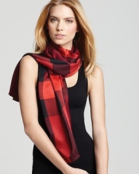 In silky satin, this Burberry scarf showcases the British brand's signature check print in a vibrant red palette. In silky satin, this Burberry scarf showcases the British brand's signature check print in a vibrant red palette.