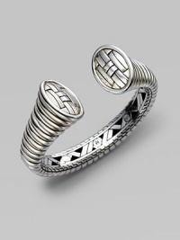 From the Bedeg Collection. A bold and sleek ribbed cuff, gracefully tapered, with a woven pattern on the end caps and a hidden hinge on one side.Sterling silver Diameter, about 2½ Width, about ¾ Hinged Made in Bali