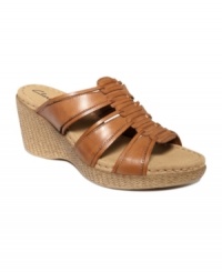 Good vibes are coming your way. Embrace the essence of hippie-chic in Clarks' Lilly Jazz wedge sandals. A textured heel and leather straps combine for natural style. Good vibes are coming your way. Embrace the essence of hippie-chic in Clarks' Lilly Jazz wedge sandals. A textured heel and leather straps combine for natural style.