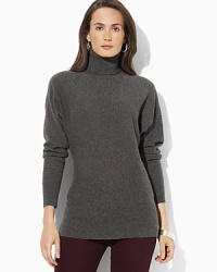 A feminine turtleneck sweater is crafted from indulgent cashmere with relaxed dolman sleeves for effortless style. A feminine turtleneck sweater is crafted from indulgent cashmere with relaxed dolman sleeves for effortless style.