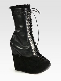 Lace-up leather style on a sky-high suede platform, topped with shearling trim. Suede and leather-covered wedge, 5½ (140mm)Hidden platform, 1¾ (45mm)Compares to a 3¾ heel (95mm)Shaft, 10Leg circumference, 11Leather and suede upper with shearling trimLeather liningRubber solePadded insoleMade in Italy Lace-up leather style on a sky-high suede platform, topped with shearling trim. Suede and leather-covered wedge, 5½ (140mm)Hidden platform, 1¾ (45mm)Compares to a 3¾ heel (95mm)Shaft, 10Leg circumference, 11Leather and suede upper with shearling trimLeather liningRubber solePadded insoleMade in Italy