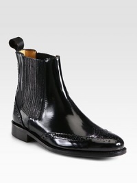 Traditional wingtip detailing on lustrous patent leather, with stretch elastic paneling for easy on and off. Stacked heel, 1 (25mm)Patent leather upper with side stretch panelsPull-on styleLeather lining and solePadded insoleMade in Italy Traditional wingtip detailing on lustrous patent leather, with stretch elastic paneling for easy on and off. Stacked heel, 1 (25mm)Patent leather upper with side stretch panelsPull-on styleLeather lining and solePadded insoleMade in Italy