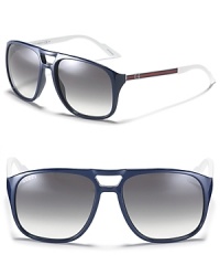 Thick double bridge frames with sporty striped arms and a gradient lenses, a modern take on the classic aviator. Thick double bridge frames with sporty striped arms and a gradient lenses, a modern take on the classic aviator.