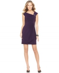 An asymmetrical neckline with a beaded, brooch-like embellishment dresses up this petite silhouette by Jessica Howard. An asymmetrical neckline with a beaded, brooch-like embellishment dresses up this petite silhouette by Jessica Howard.