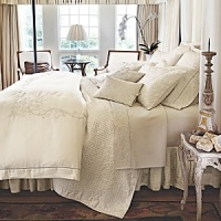 This luxurious all-white bedding ensemble incorporates couture-inspired details - from intricate floral embroidery to elegant silk matelasse - for a feminine vision of modern romance. This luxurious all-white bedding ensemble incorporates couture-inspired details - from intricate floral embroidery to elegant silk matelasse - for a feminine vision of modern romance.