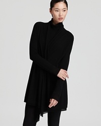 A signature Donna Karan New York cozy is the ultimate layering piece, cut in an open silhouette with a elegant draped collar that effortlessly frames silky camis and stretch tees. A signature Donna Karan New York cozy is the ultimate layering piece, cut in an open silhouette with a elegant draped collar that effortlessly frames silky camis and stretch tees.