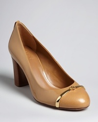 Smoothly polished leather capped off with delicate goldtone metal accents makes these Tory Burch pumps musts for the office. Smoothly polished leather capped off with delicate goldtone metal accents makes these Tory Burch pumps musts for the office.