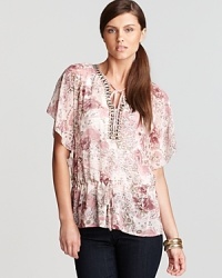 Ornate florals bloom against a billowing Shiloh770 blouse, unexpectedly trimmed with metallic studs for a tough take on femininity. Ornate florals bloom against a billowing Shiloh770 blouse, unexpectedly trimmed with metallic studs for a tough take on femininity.