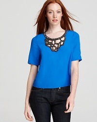 Edgy cutouts and glamorous beading meet for statement style on this Plenty by Tracy Reese top, cut in a cropped silhouette that compliments directional high-waist pants and skirts. Edgy cutouts and glamorous beading meet for statement style on this Plenty by Tracy Reese top, cut in a cropped silhouette that compliments directional high-waist pants and skirts.