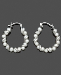 A not-so-traditional pair of hoop earrings. A spiraling sterling silver setting adds a simple twist to shimmery cultured freshwater pearls (4-5 mm). Approximate diameter: 9/10 inch. A not-so-traditional pair of hoop earrings. A spiraling sterling silver setting adds a simple twist to shimmery cultured freshwater pearls (4-5 mm). Approximate diameter: 9/10 inch.