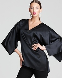 Take your style to epic proportions in a fluid Elie Tahari blouse flaunting exaggerated slit sleeves and a plunging neckline dripping with dazzle. Take your style to epic proportions in a fluid Elie Tahari blouse flaunting exaggerated slit sleeves and a plunging neckline dripping with dazzle.