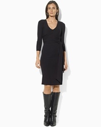 A sleek jersey dress is crafted in a figure-flattering wrap silhouette and finished with chic three-quarter-length sleeves. A sleek jersey dress is crafted in a figure-flattering wrap silhouette and finished with chic three-quarter-length sleeves.
