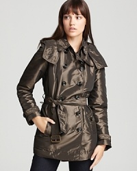 A metallic luster lends subtle shimmer to a down Burberry Brit coat for a style guaranteed to illuminate the day, then ignite the night. A metallic luster lends subtle shimmer to a down Burberry Brit coat for a style guaranteed to illuminate the day, then ignite the night.