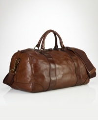 Invoking the classic feel of gentleman's vintage sporting holdalls, an essential gym bag is crafted from sturdy leather with an embossed signature luggage tag for timeless style. Invoking the classic feel of gentleman's vintage sporting holdalls, an essential gym bag is crafted from sturdy leather with an embossed signature luggage tag for timeless style.