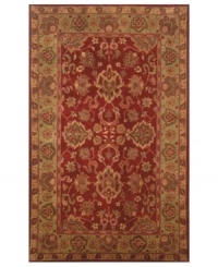 Drawing inspiration from the sandy ruins of ancient Petra and the traditional designs of India, this elegant, hand-tufted rug presents a rich decorative history set against a subtle red backdrop and accented with multiple gold and green tones.