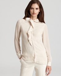 A decadently ruffled neckline sprawls down a sheer Jones New York Collection blouse for an effortlessly romantic look. A decadently ruffled neckline sprawls down a sheer Jones New York Collection blouse for an effortlessly romantic look.