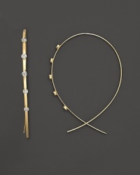 Diamond dot Lana's slim, elegant 14K yellow gold hoop earrings. Diamond dot Lana's slim, elegant 14K yellow gold hoop earrings.