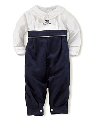 A cotton coverall is crafted with nautical-inspired touches and an embroidered rocking horse for a playful finish. A cotton coverall is crafted with nautical-inspired touches and an embroidered rocking horse for a playful finish.