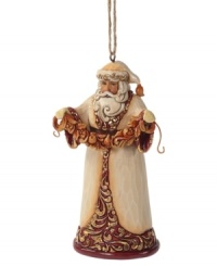 Dressed – not in his traditional red and white getup – but in a beautiful coat of ivory, burgundy and gold, this Santa ornament from Jim Shore makes for a memorably elegant tree. Dressed – not in his traditional red and white getup – but in a beautiful coat of ivory, burgundy and gold, this Santa ornament from Jim Shore makes for a memorably elegant tree.