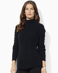 A cozy mockneck sweater is reimagined for the modern woman with a chic peplum hem.