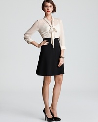 One-step dressing, this DKNY system dress exudes polished perfect, pairing a sleek black skirt with a sheer neck-tie blouse for effortless sophistication. One-step dressing, this DKNY system dress exudes polished perfect, pairing a sleek black skirt with a sheer neck-tie blouse for effortless sophistication.