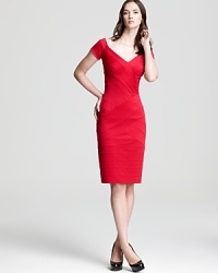 Tadashi Shoji takes on the bandage dress with this bold off-the-shoulder creation, crafted in a brilliant red hue.