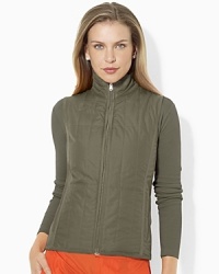 A chic quilted vest is crafted in sleek microfiber and reverses between two bold colored sides for easy athletic styling options. A chic quilted vest is crafted in sleek microfiber and reverses between two bold colored sides for easy athletic styling options.