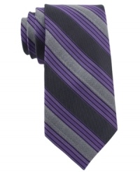 In a traditional stripe pattern, this Calvin Klein skinny tie recalls classic haberdashery style. In a traditional stripe pattern, this Calvin Klein skinny tie recalls classic haberdashery style.