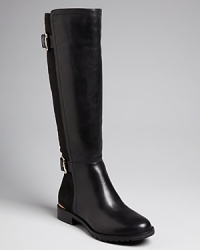 These Isaac Mizrahi New York boots feature stretch Lycra backs for the perfect, easy-on fit. Metal logo plates and shining buckles pull the look together; it's the ideal comfort-meets-style go-to. These Isaac Mizrahi New York boots feature stretch Lycra backs for the perfect, easy-on fit. Metal logo plates and shining buckles pull the look together; it's the ideal comfort-meets-style go-to.