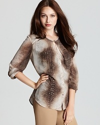 A faint dusting of sequins enlivens a snakeskin-print Jones New York Collection blouse, flaunting an intricately pleated neckline for untamed glamour. A faint dusting of sequins enlivens a snakeskin-print Jones New York Collection blouse, flaunting an intricately pleated neckline for untamed glamour.