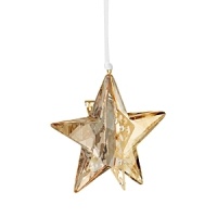 Formed of sparkling Swarovski crystal in a warm golden hue, this star-shaped ornament shines in bold dimension. Formed of sparkling Swarovski crystal in a warm golden hue, this star-shaped ornament shines in bold dimension.