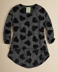 It's in the details: Kiddo's tunic creates an elegant look with ruched 3/4 sleeves, a dramatic high/low hem and sweet repeating heart prints. It's in the details: Kiddo's tunic creates an elegant look with ruched 3/4 sleeves, a dramatic high/low hem and sweet repeating heart prints.