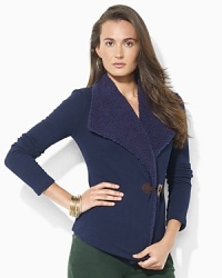 A cozy fleece cardigan is accented with plush faux shearling at the neckline and a heritage toggle closure. A cozy fleece cardigan is accented with plush faux shearling at the neckline and a heritage toggle closure.