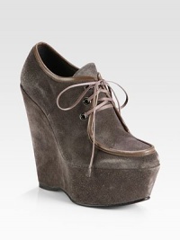 Smooth leather trim lines this lace-up suede design, elevated by a tall platform wedge. Self-covered wedge, 5¾ (145mm)Covered platform, 2 (50mm)Compares to a 3¾ heel (95mm)Suede upper with leather trimLeather liningRubber solePadded insoleImported