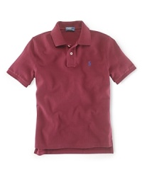 A classic polo shirt crafted from breathable cotton mesh is tailored in a short-sleeved silhouette for preppy, warm-weather style. A classic polo shirt crafted from breathable cotton mesh is tailored in a short-sleeved silhouette for preppy, warm-weather style.