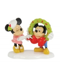 Mickey and Minnie flirt with a little Christmas romance, giggling as they put the finishing touches on a Mickey's Village holiday wreath. By Department 56. Mickey and Minnie flirt with a little Christmas romance, giggling as they put the finishing touches on a Mickey's Village holiday wreath. By Department 56.