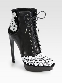 A towering horn heel lifts this leather and velvet ankle boot, accented with dramatically embroidered lace. Leather-covered heel, 5¼ (130mm)Leather covered platform, 1 (25mm)Compares to a 4¼ heel (110mm)Leather and velvet upper with lace overlayLeather lining and solePadded insoleMade in Italy A towering horn heel lifts this leather and velvet ankle boot, accented with dramatically embroidered lace. Leather-covered heel, 5¼ (130mm)Leather covered platform, 1 (25mm)Compares to a 4¼ heel (110mm)Leather and velvet upper with lace overlayLeather lining and solePadded insoleMade in Italy