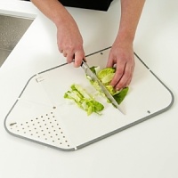 The patented Rinse & Chop Joseph Joseph chopping board folds to create a strainer at one end, and a chute at the other. Fold and lock the board into position to rinse; open and flatten to chop, then fold again to pour food easily into a pan. The patented Rinse & Chop Joseph Joseph chopping board folds to create a strainer at one end, and a chute at the other. Fold and lock the board into position to rinse; open and flatten to chop, then fold again to pour food easily into a pan.